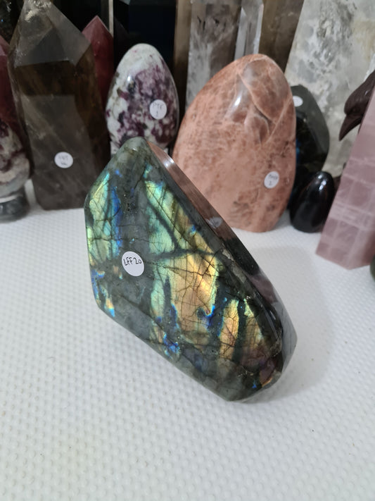 A large polished Labradorite crystal freeform with a stunning flash that is approximately 13.5cm by 11.5cm in size