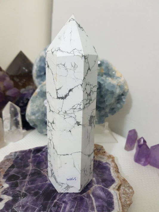 A polished White Howlite crystal generator that stands upright at approximately 19.5 centimetres tall and 6 centimetres wide