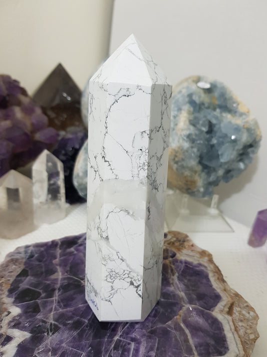 A polished White Howlite crystal generator that stands upright at approximately 16.5 centimetres tall and 5 centimetres wide